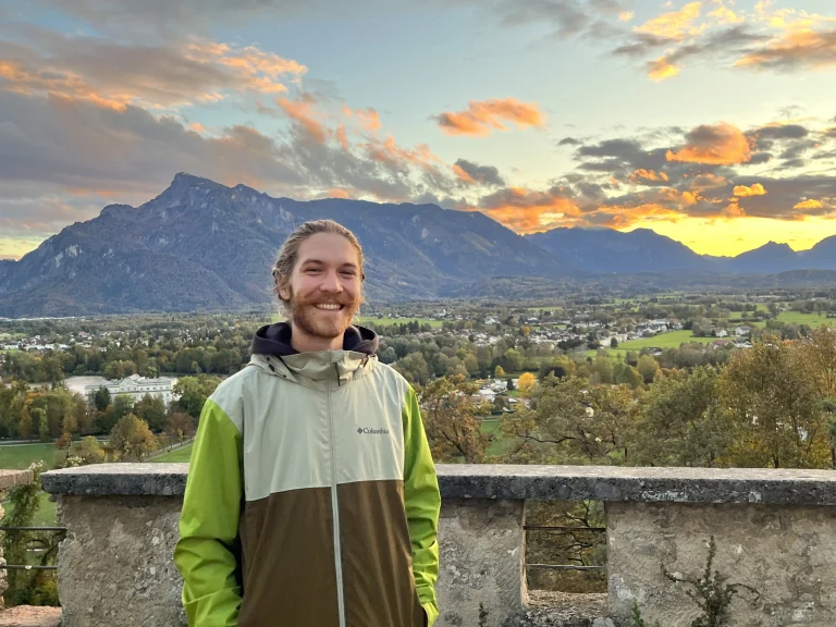 Patrick Varga, founder of Aftab, smiling with a beautiful sunset behind.